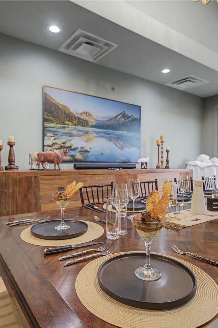 Dining table details with glassware, place settings, and passed bites