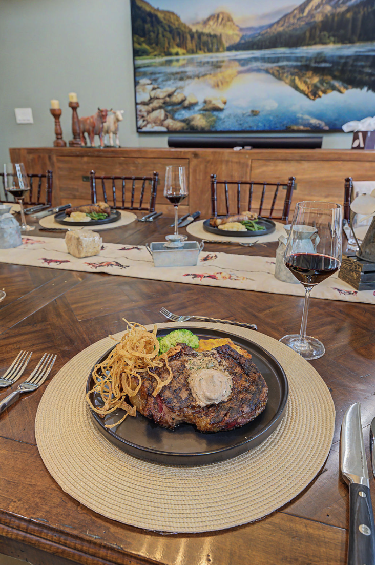 Steak dinner service at a set table with wine